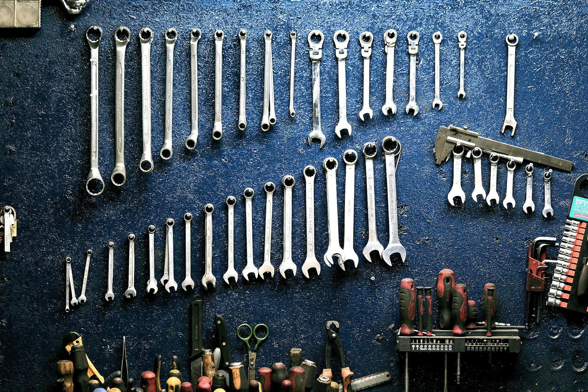 Professional plumbing tools and wrenches arranged on a workbench